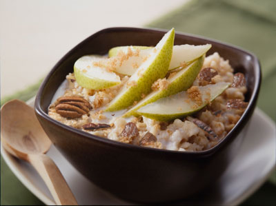 oatmeall topped with pears and walnuts in a bowl