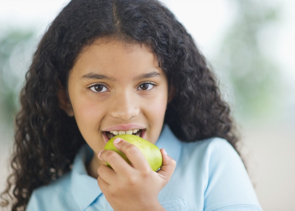 girl eating pear