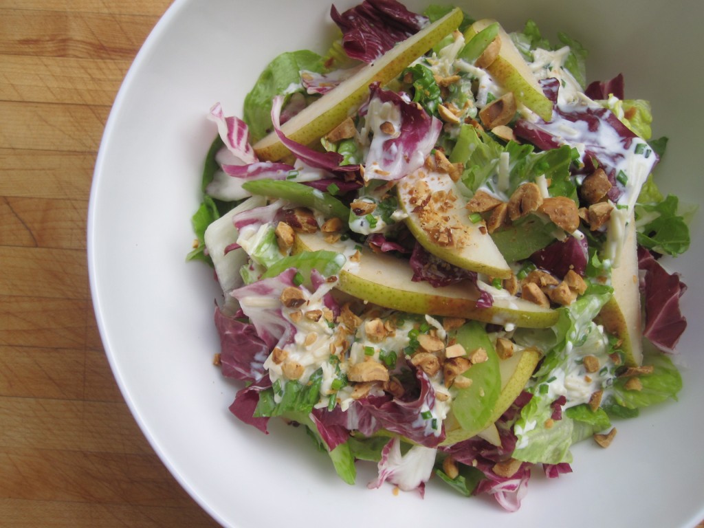 Mixed greens topped with fresh, sliced pears