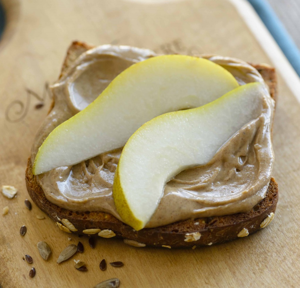 Whole wheat toast topped with peanut butter and sliced pears