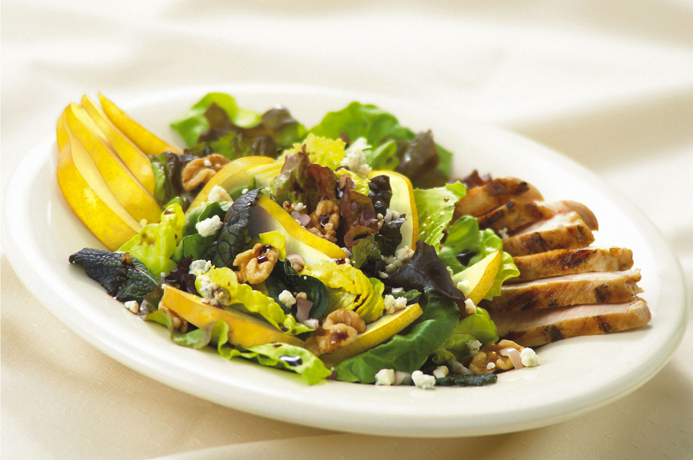 Fresh pears atop mixed greens