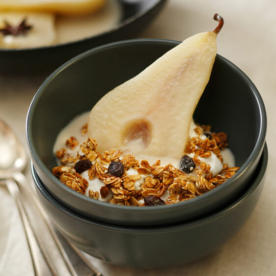 Star anise and coconut poached pear with yogurt and granola