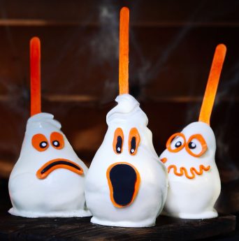 31443466 - three homemade creative halloween candy pears or white chocolate ghosts on a stick